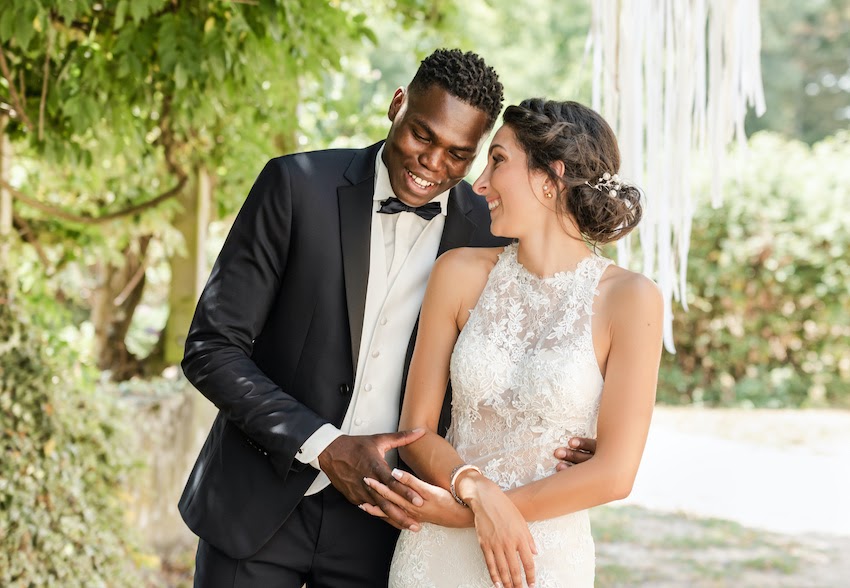 Wedding Invitation Wording: bride and groom happily hugging each other